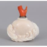 A 19TH/20TH CENTURY WHITE CORAL SNUFF BOTTLE & RED CORAL STOPPER, the sides carved in high relief