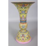 A GOOD QUALITY CHINESE FAMILLE ROSE YELLOW GROUND PORCELAIN GU VASE, the sectional vase with a