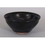 A CHINESE SONG STYLE OIL SPOT CERAMIC TEA BOWL, the lustrous black glaze incorporating areas of