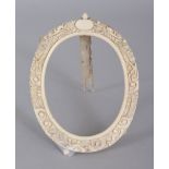 A SMALL 19TH CENTURY CHINESE CANTON IVORY OVAL PICTURE FRAME, the rim carved with dragons and