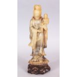 A GOOD QUALITY 19TH/20TH CENTURY CHINESE CARVED SOAPSTONE FIGURE OF GUANYIN, standing on a lotus