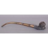 A 19TH/20TH CENTURY THAI OPIUM PIPE, with a moulded grey clay bowl and a banded metal stem, 10.5in