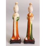 A GOOD PAIR OF CHINESE TANG DYNASTY SANCAI GLAZED POTTERY FIGURES OF STANDING LADIES, with fitted