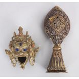 TWO 20TH CENTURY TIBETAN METAL OBJECTS, comprising a brass incense burner in the form of a head of