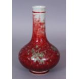 A CHINESE PEACH BLOOM GLAZED PORCELAIN BOTTLE VASE, the base with a six-character Kangxi mark, 7.1in