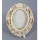 A SMALLER 19TH CENTURY CHINESE CANTON IVORY OVAL PICTURE FRAME, 2.4in x 2in.