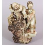 A GOOD 18TH/19TH CENTURY CHINESE CARVED SOAPSTONE GROUP, depicting Guanyin standing on rockwork in