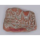 A 20TH CENTURY TIBETAN PRAYER STONE, of irregular form, the red pigmented surface engraved with a