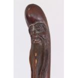 A CHINESE CARVED WOOD WALKING STICK, 3ft 6in long.