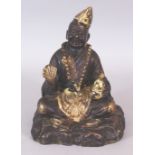 A CHINESE GILT BRONZE FIGURE OF A LAUGHING LAMA PRIEST, 6.25in wide at widest point of base & 7.75in