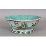 A CHINESE FAMILLE ROSE PORCELAIN BOWL, painted to one side with Shou Lao seated in a garden, 7.6in