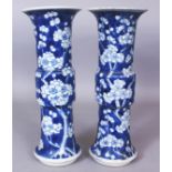 A PAIR OF 19TH CENTURY CHINESE BLUE & WHITE PORCELAIN GU VASES, the sides of each painted with