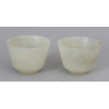 A PAIR OF CHINESE PALE CELADON JADE WINE CUPS, 2.2in diameter & 1.6in high.