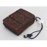 A JAPANESE CARVED WOOD TWO CASE INRO, together with a glass ojime, the inro 3.75in x 3in x 1.3in