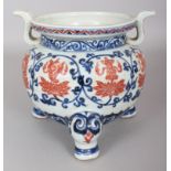 A CHINESE MING STYLE COPPER-RED & UNDERGLAZE-BLUE PORCELAIN TRIPOD, decorated with Buddhist