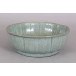 A CHINESE SONG STYLE RU WARE CELADON CRACKLEGLAZE PORCELAIN BOWL, with a petal moulded rim, 7.5in