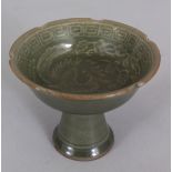 A CHINESE SONG/YUAN STYLE CELADON PORCELAIN STEM BOWL, the interior decorated with a phoenix, 4.