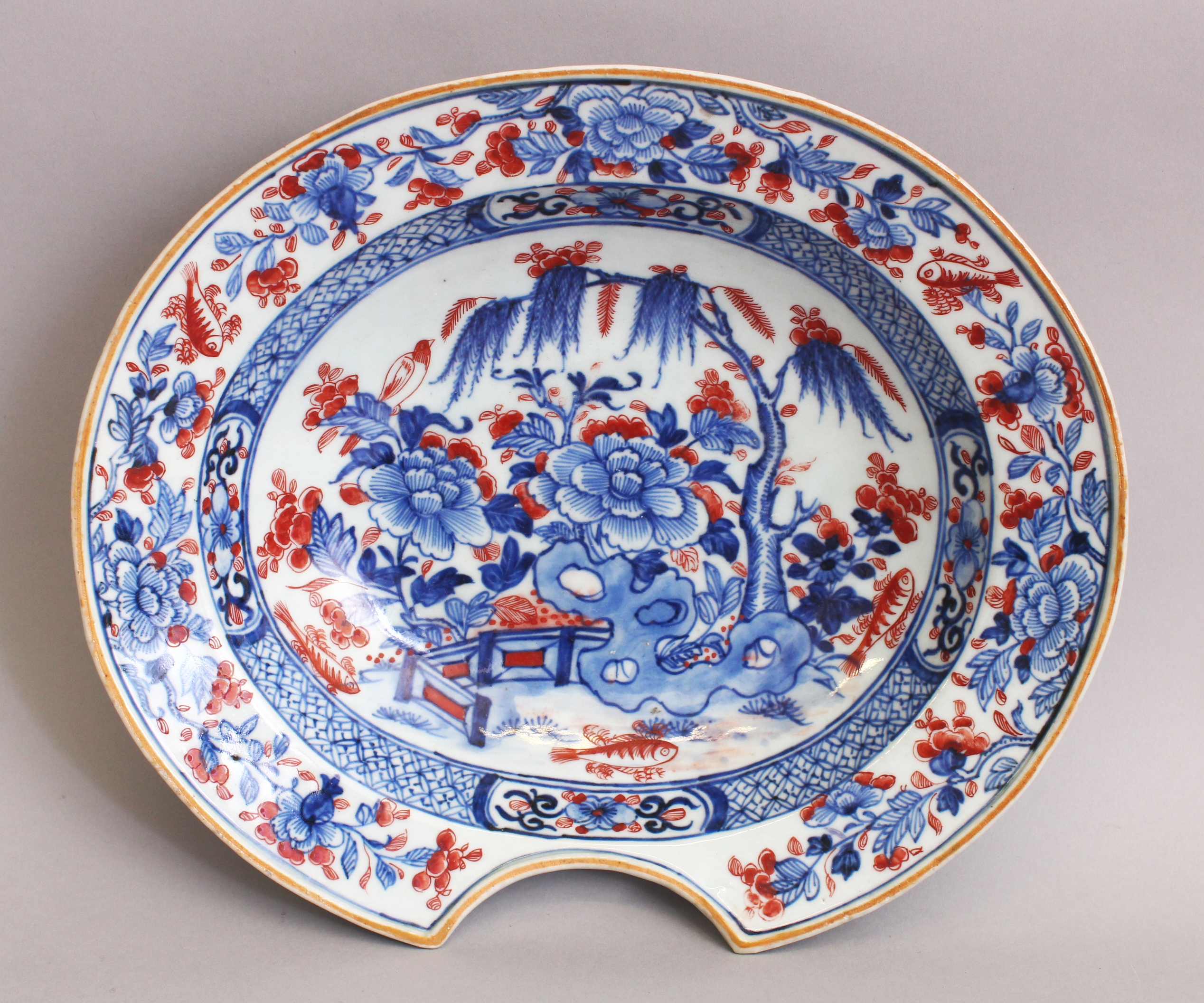 AN 18TH CENTURY CHINESE QIANLONG PERIOD UNDERGLAZE-BLUE & IRON-RED PORCELAIN BARBERS BOWL, the