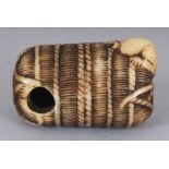 A GOOD QUALITY JAPANESE MEIJI PERIOD STAINED IVORY NETSUKE OF RAT BURROWING INTO A STRAW BALE, 1.5in