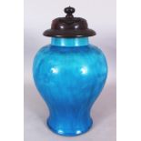 A CHINESE TURQUOISE GLAZED PORCELAIN VASE, together with a fine quality ruyi pierced fitted hardwood