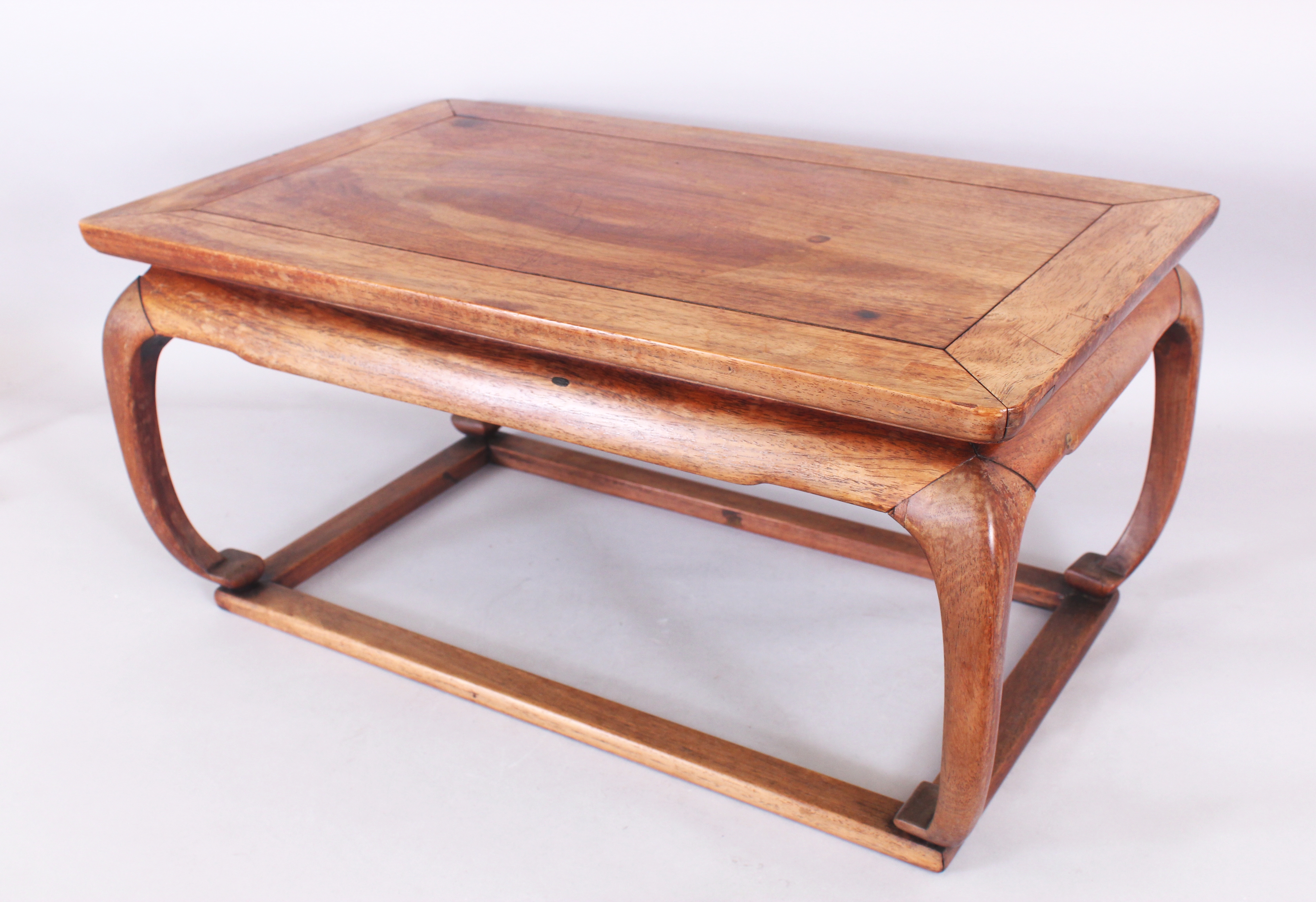 A GOOD QUALITY 19TH/20TH CENTURY CHINESE LOW HARDWOOD RECTANGULAR TABLE, supported on scroll feet