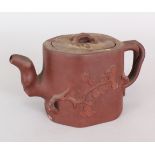 A 19TH CENTURY CHINESE YIXING POTTERY TEAPOT & COVER, the sides moulded in relief with pine,