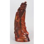 AN EARLY 20TH CENTURY CHINESE HORN CARVING OF A STANDING BEARDED IMMORTAL, bearing a basket of