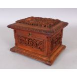 A 19TH CENTURY CHINESE CANTON CARVED WOOD RECTANGULAR CASKET, the hinged cover and sides carved with