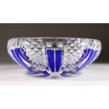A BOHEMIAN CUT GLASS BOWL, with blue overlaid decoration. 11ins diameter.