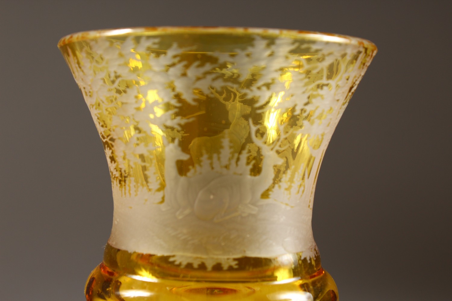 A BOHEMIAN AMBER CUT GOBLET, engraved with deer in a wood. 7ins high. - Image 4 of 6