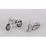 A PAIR OF NOVELTY SILVER MOTOR CYCLES.