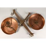 A SET OF 19TH CENTURY WROUGHT IRON HANGING WEIGHING SCALES, the pair of copper pans engraved with