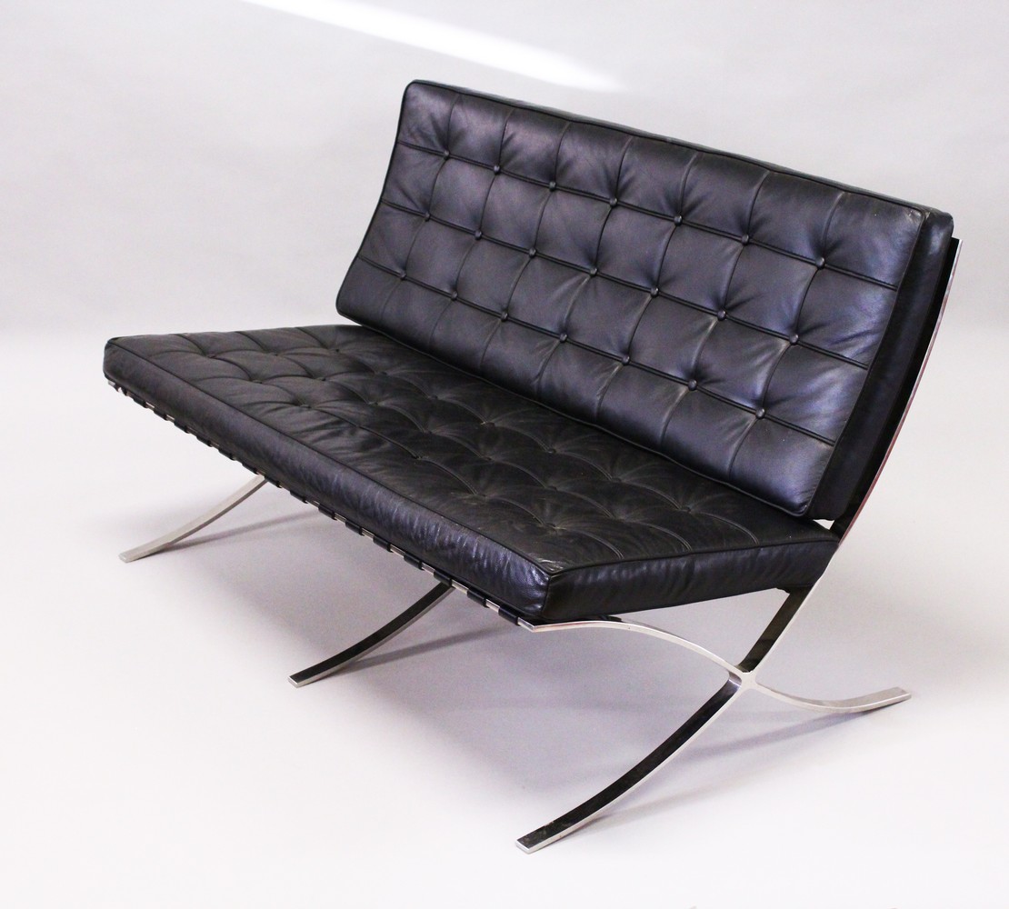 MIES VAN DER ROHE, A BARCELONA SETTEE, with button upholstered black leather back and seat cushions,