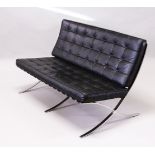 MIES VAN DER ROHE, A BARCELONA SETTEE, with button upholstered black leather back and seat cushions,