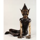 A TWO-COLOUR BRONZE PIXIE sitting on the floor. 2ft high.