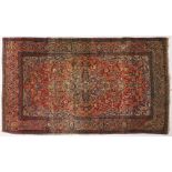 A PERSIAN RUG, with all-over pattern within a deep border. 7ft x 4ft 3ins.