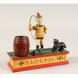 A CAST IRON MONEY BOX, "TRICK DOG". 8ins long.