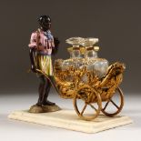 A GOOD PALAIS ROYAL TWO BOTTLE SCENT CRUET, as a negro man pushing a cart with two gilded glass