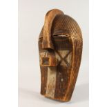 A CASED WOOD TRIBAL MASK, with incised and painted decoration. 15ins high.