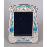 AN ART NOUVEAU STYLE SILVER AND ENAMEL FRAME. 8.5ins x 6ins.