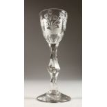 A GEORGIAN WINE GLASS, with facet stem, the bowl engraved with honeysuckle. 6ins high.
