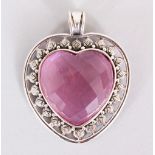 A SILVER AND PINK ART PENDANT.
