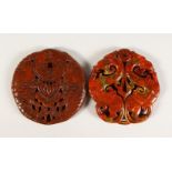 TWO CARVED AND PIERCED CHINESE ROUNDELS.