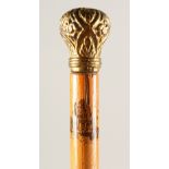 A SLENDER WALKING STICK, with painted shaft and gilt metal pommels. 35.5ins long.