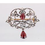 A 9CT GOLD AND SILVER BROOCH set with pearls, garnets and diamonds.