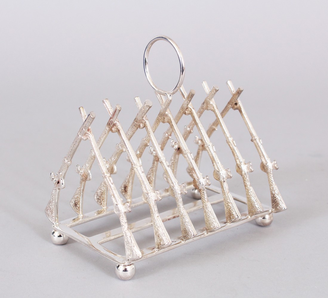 A PLATED TOAST RACK, seven pairs of crossed rifles.