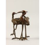 A JAPANESE BRONZE GROUP OF THREE STORKS. 4cms high.