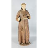 AN 18TH CENTURY CARVED WOOD AND PAINTED FIGURE OF A MONK, hand missing. 3ft 4ins high.