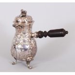 A GOOD FRENCH SILVER CHOCOLATE POT, with repousse decoration, mask spout, turned wood handle on