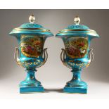 A GOOD PAIR OF SEVRES DESIGN LIGHT BLUE URN SHAPED TWO HANDLED VASES AND COVERS with reverse